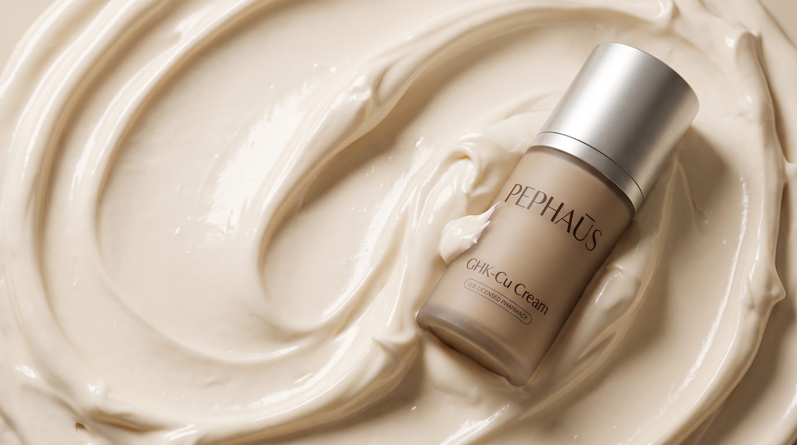 PepHaus GHK-Cu Cream bottle resting in a swirl of cream